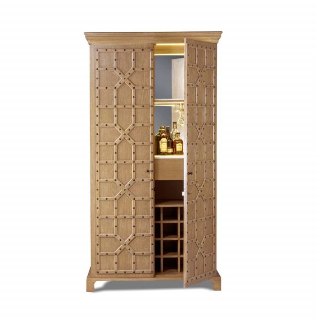 Our WA bespoke bar unit is inspired from the antique doors of Jodhpur, a style of architectural ornamentation. A perfect symbiosis of innovative design and techniques with historic heritage. The body is made of high-grade oak wood and encased in brass patina studs which accents the repetitive pattern. The interior of the cabinet features exquisite marble slabs, complemented by mirror and recessed lighting along with ample storage for wine and liquor bottles. 

Wa Bespoke - @keerthi_sageliving @ramkabadi_

Dimension - L 1245mm x W 710mm x H 2311mm
Material - Oak wood

#SageLiving #WaBespoke  #CustomMade

Explore our wide range of products at - www.sageliving.in
 #WeLoveSage #lifeathome 

#luxuryfurnituredesign  #luxuryinterior #designdetails #furniturestudio #modernlivingspace #luxuryhomes #barunit #woodenfurniture #bespokefurniture #designdetail #oakwood #storageunit #bars